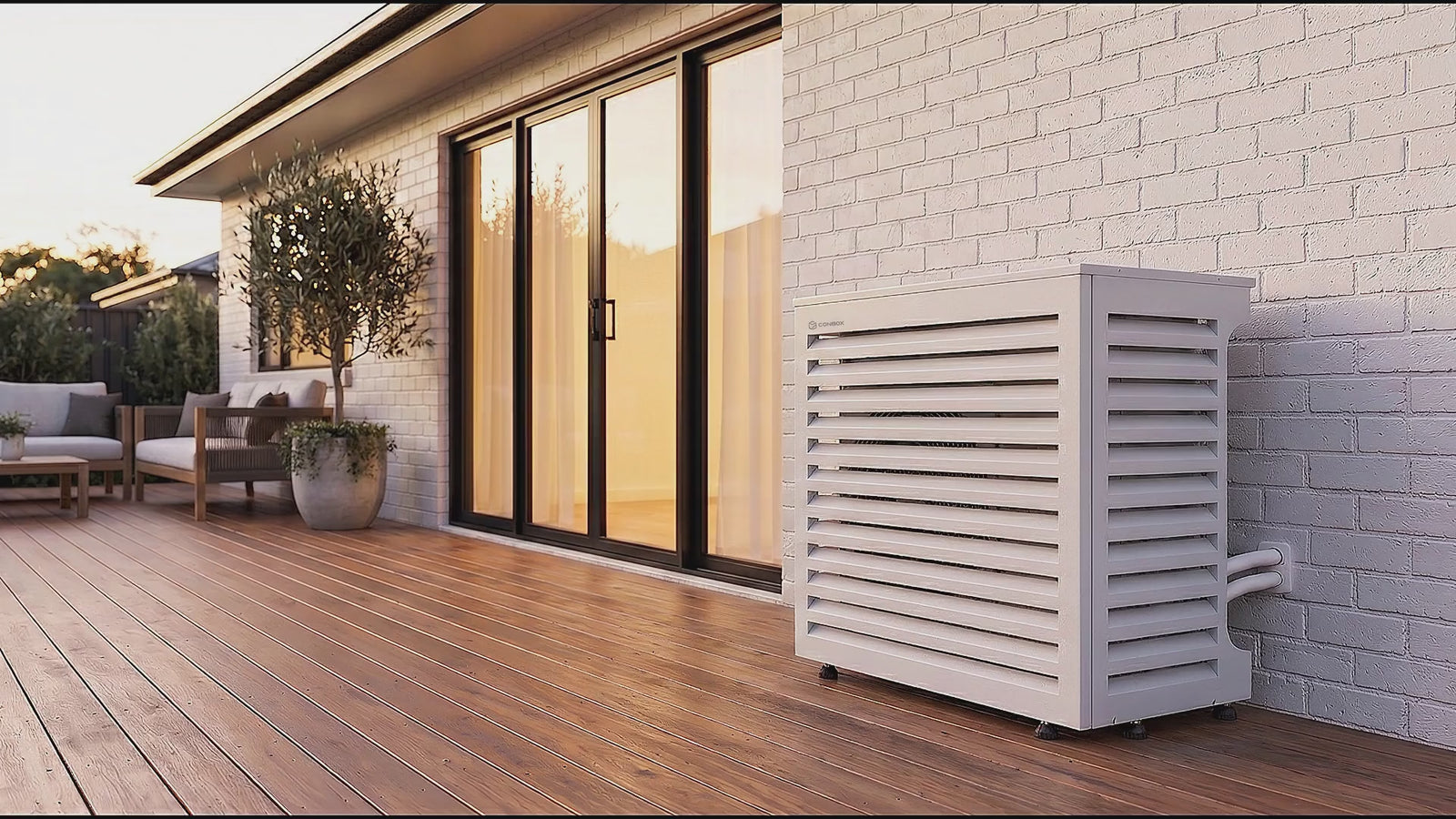 White ConBox air conditioner cover on a timber deck at golden hour